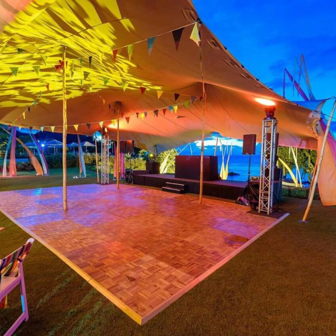 Stretch tent setup with lighting and a dance floor