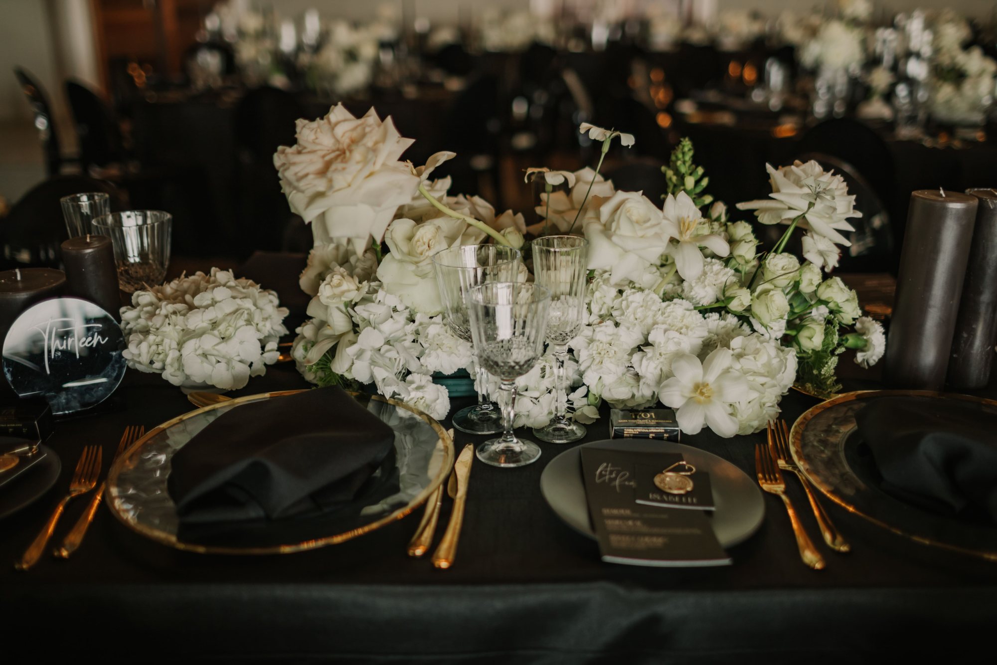 Luxurious table setting with floral decor and elegant tableware.