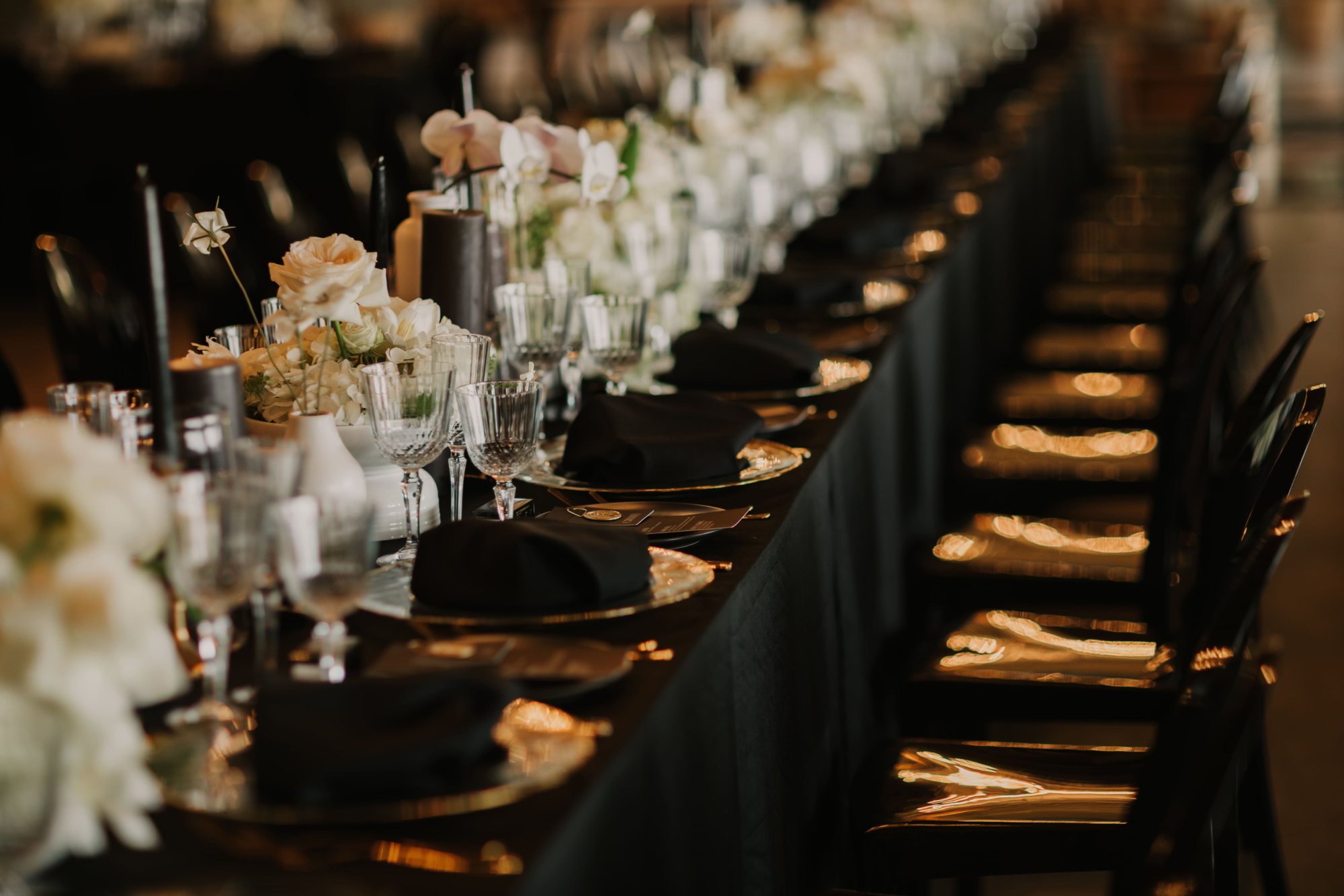 Long dining table with floral centerpieces and elegant tableware