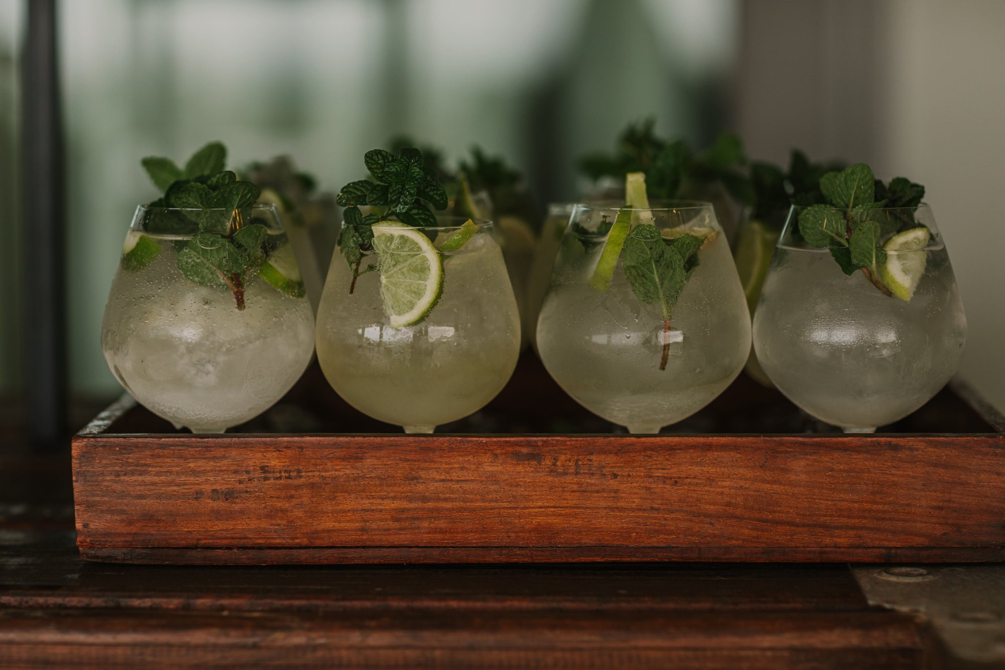 Tray of welcome drinks with mint and lime garnishes