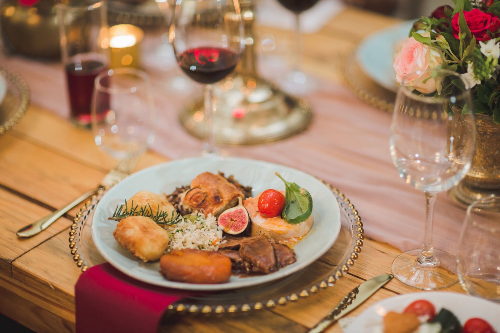 A plate with assorted gourmet food on a decorated table.
