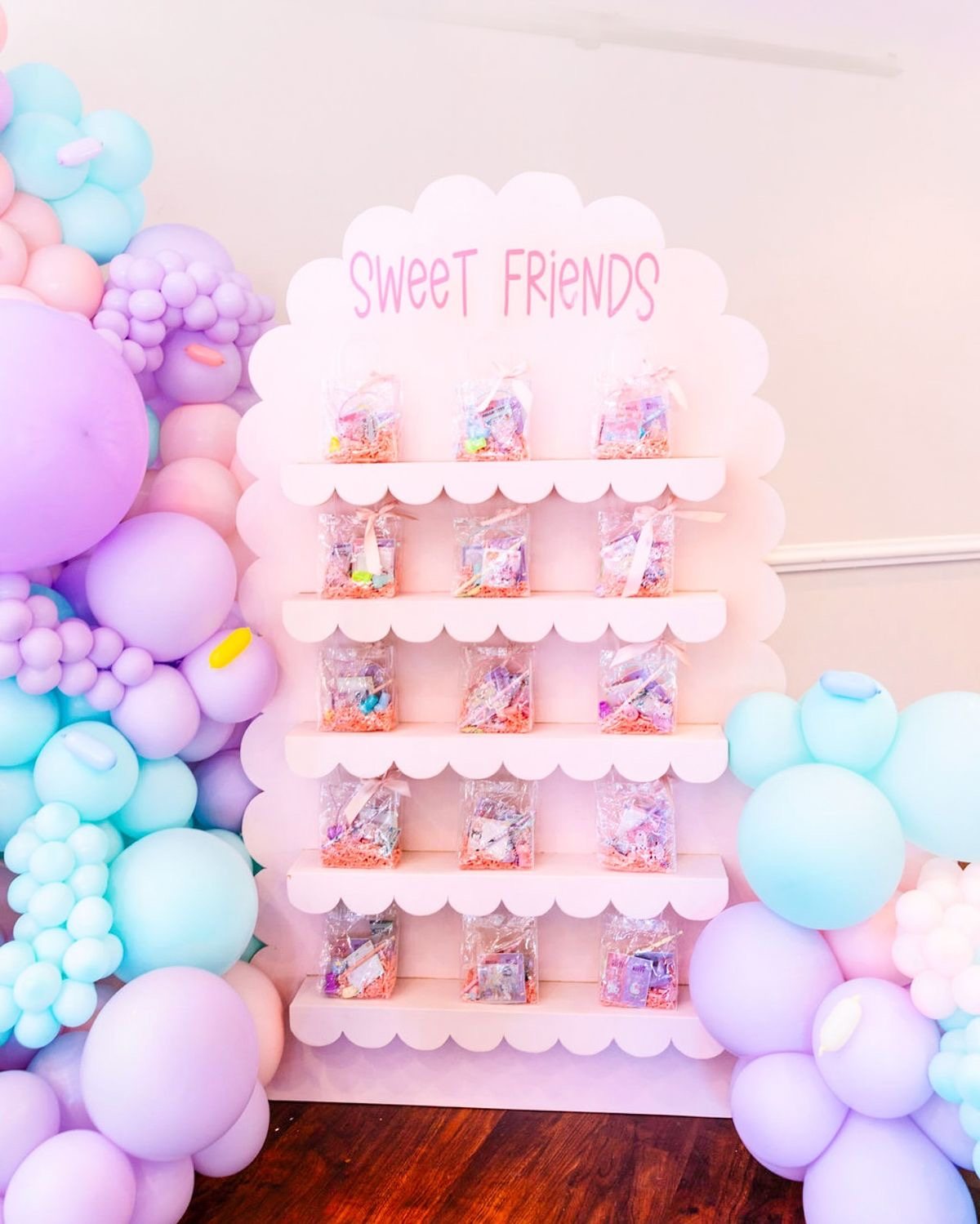 Candy platter display with colorful treats and balloon decor