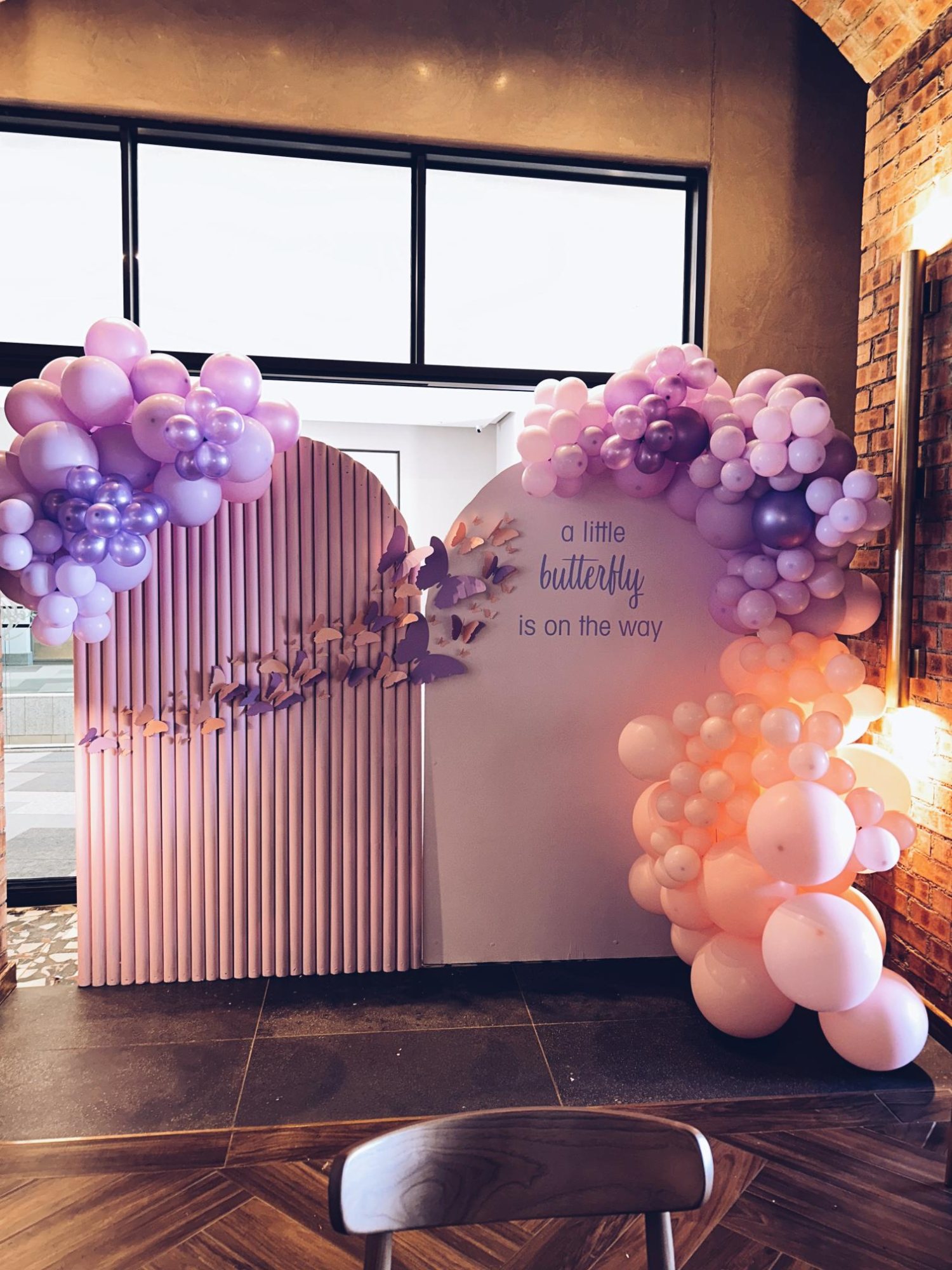 Butterfly-themed balloon wall in pastel colors