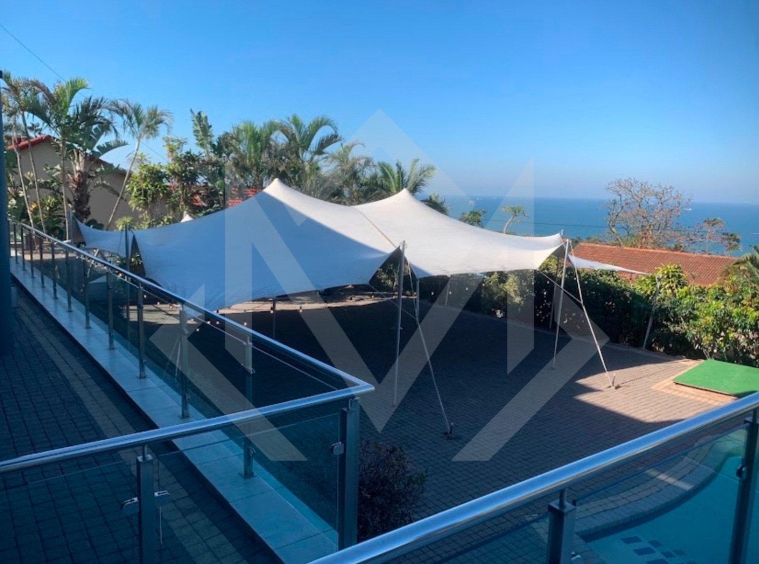 Outdoor stretch tent set up in a coastal location.