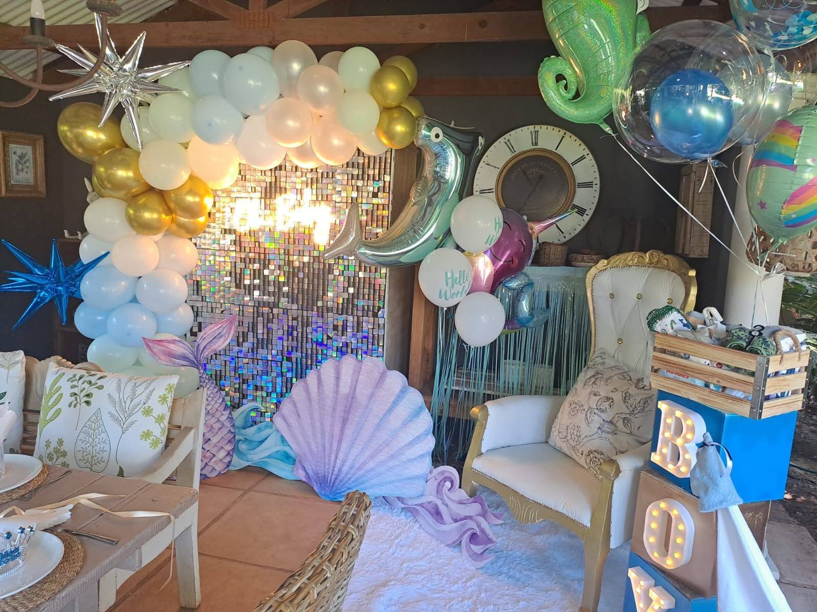 Colorful mermaid-themed party decoration with balloons and props