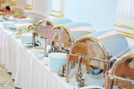 Buffet table with chafing dishes and plates