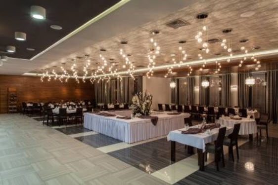 Elegant banquet hall with long tables and ambient lighting