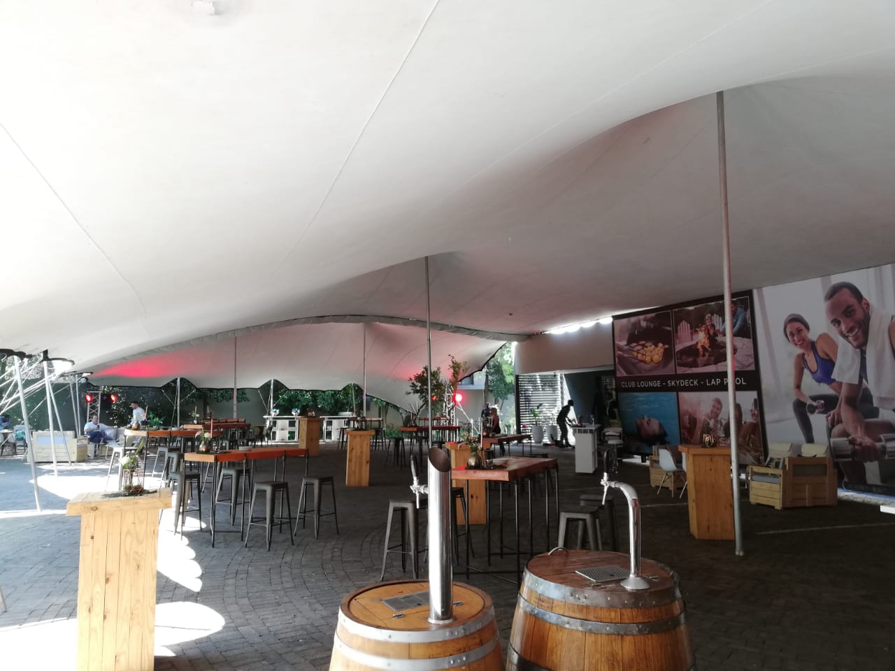 Interior view of a spacious stretch tent with bar and seating arrangements