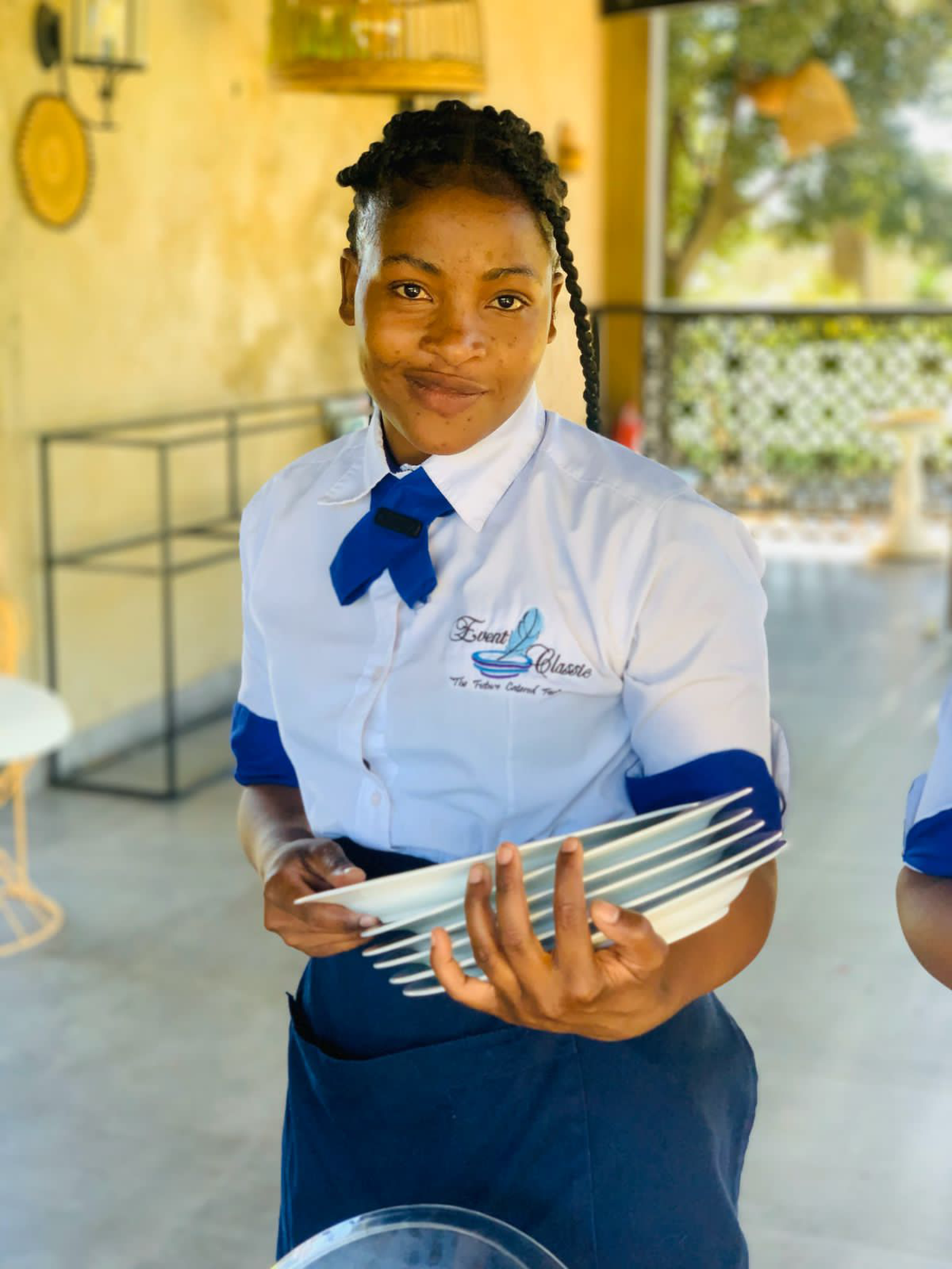 Hospitality staff member holding plates at an event