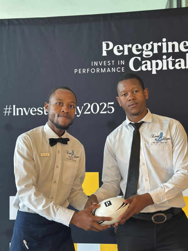 Two hospitality staff members presenting at an event