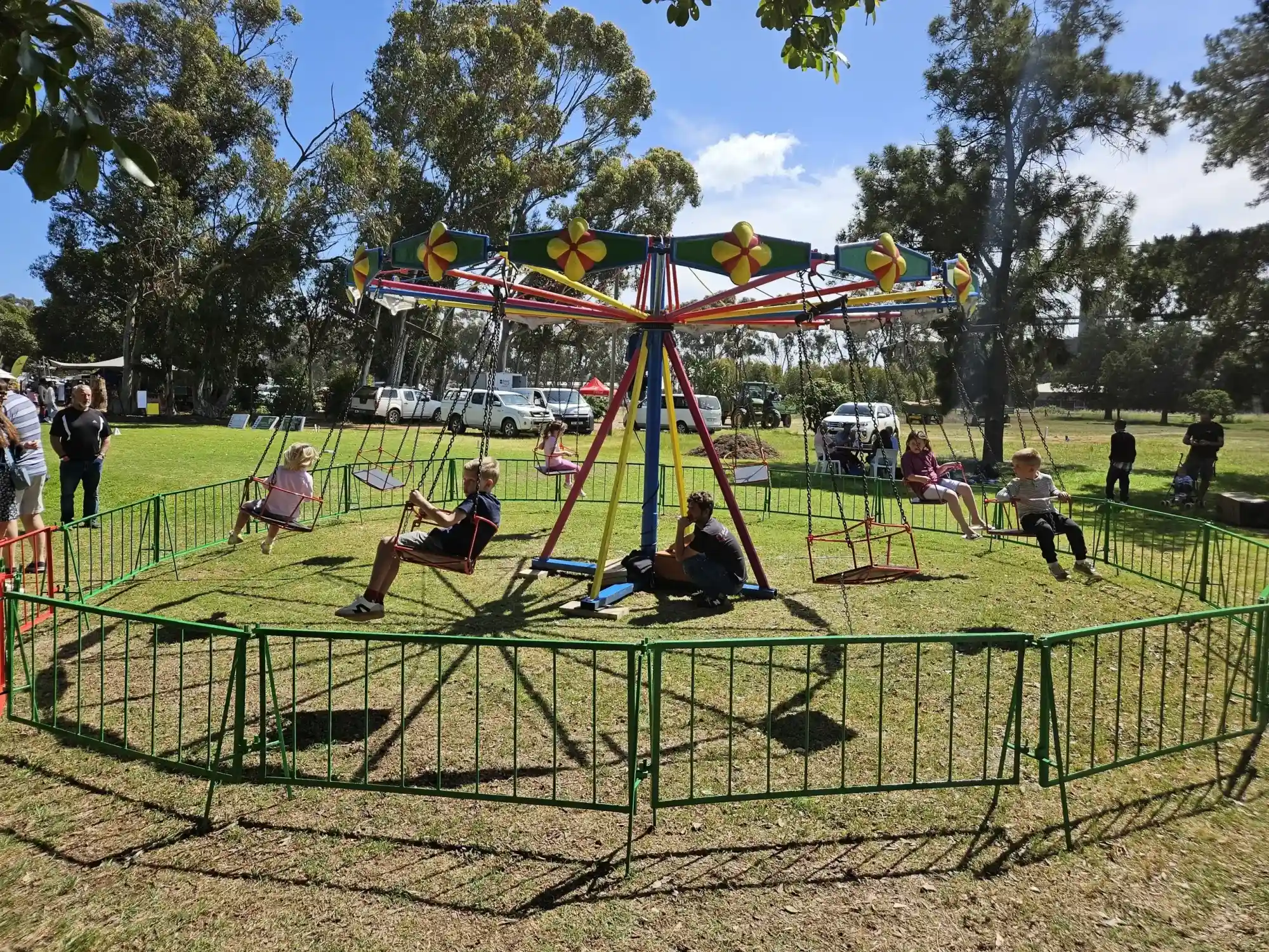 Junior swings ride set up on a grassy area