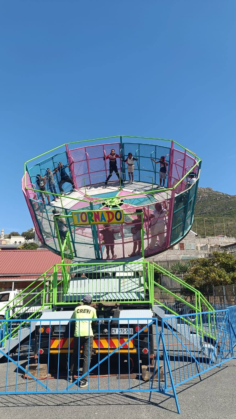 Tornado ride with colorful structure and safety barriers