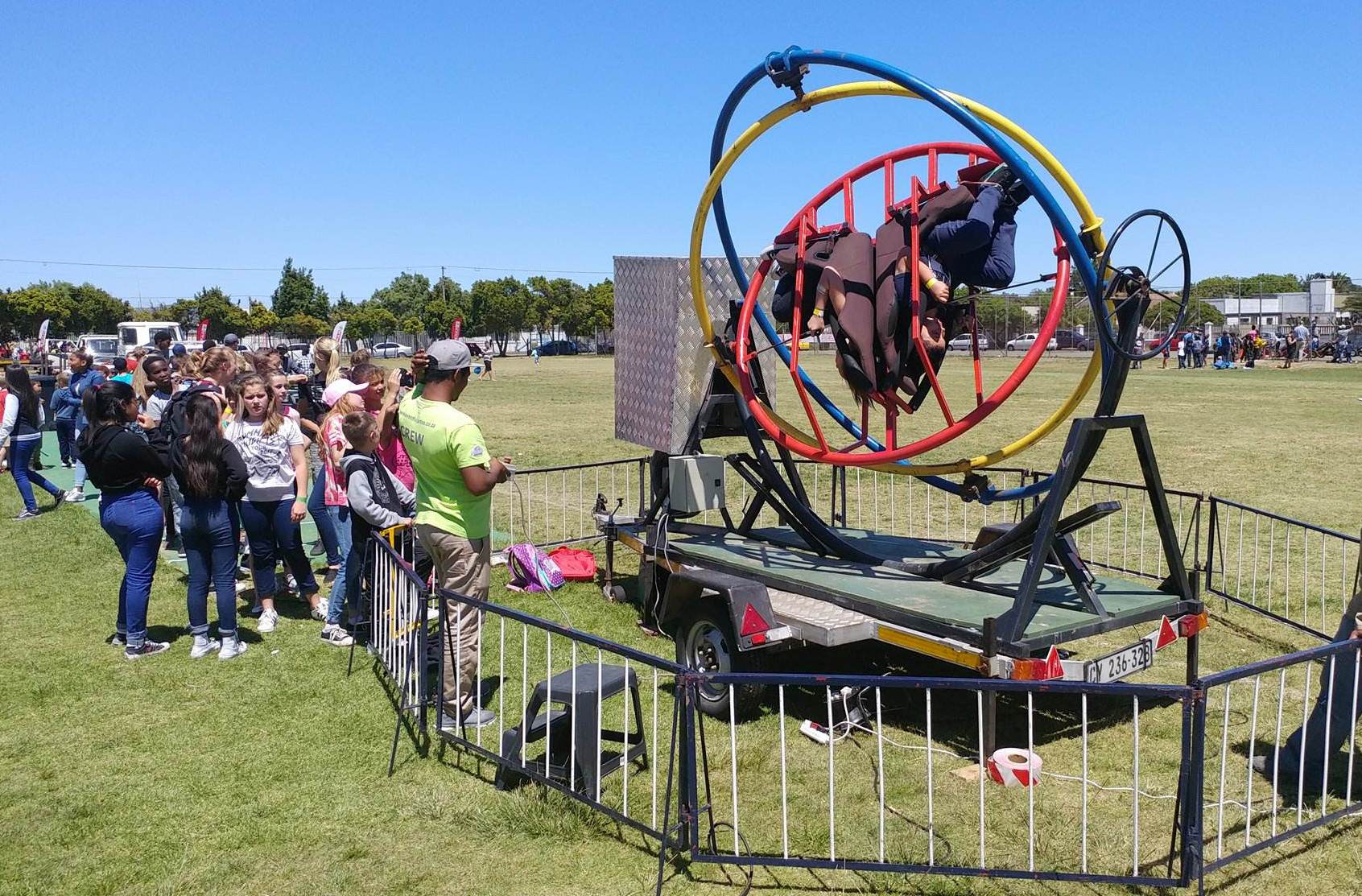 Rodeo bull attraction with participants surrounded by spectators