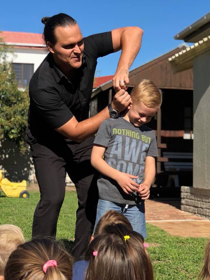 Magician performing for children outdoors