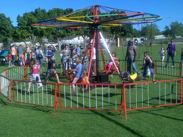 Children enjoying the Junior Swings ride at a park