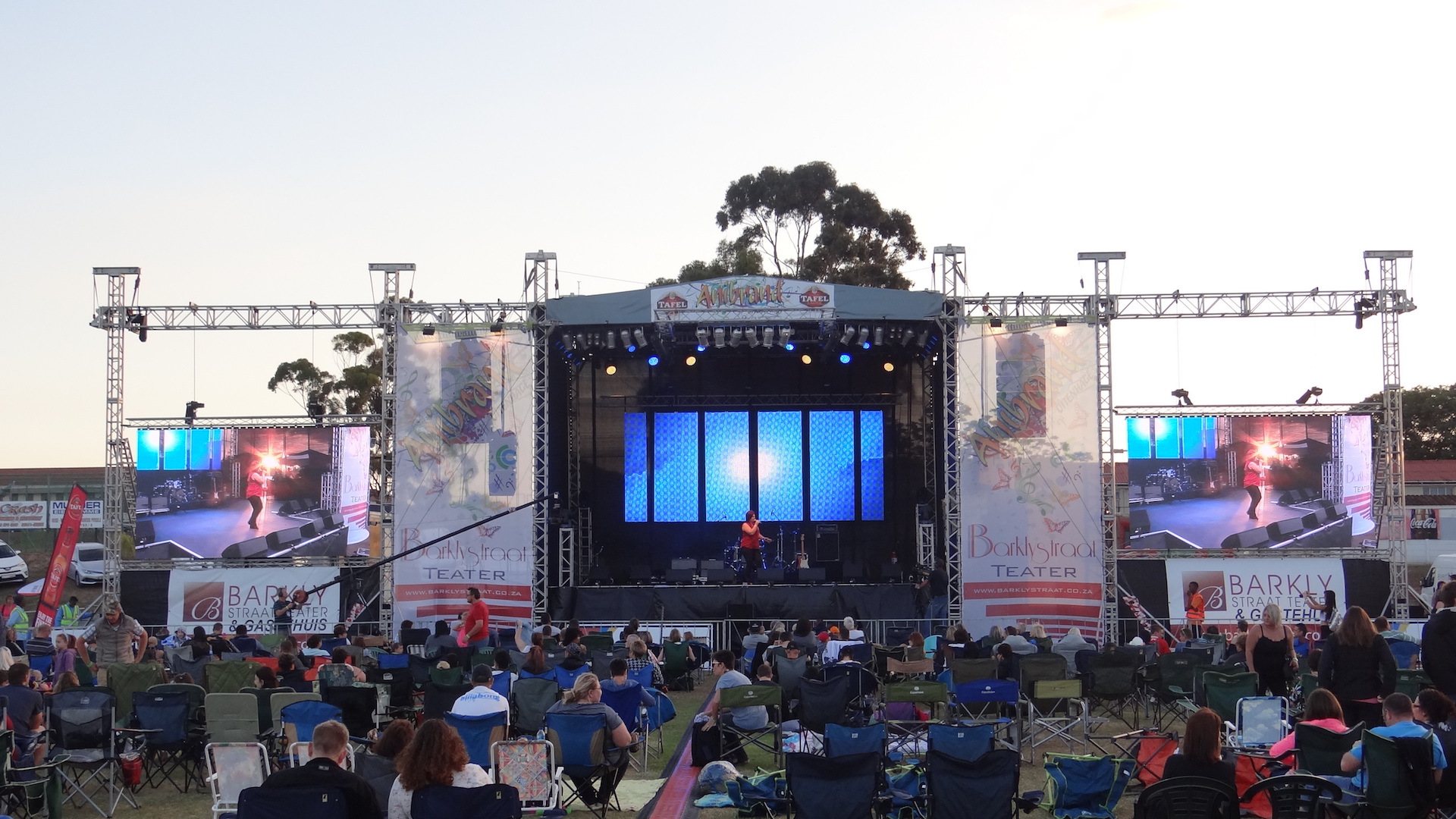 Stage with LED screens and lighting at an outdoor performance in Port Elizabeth.
