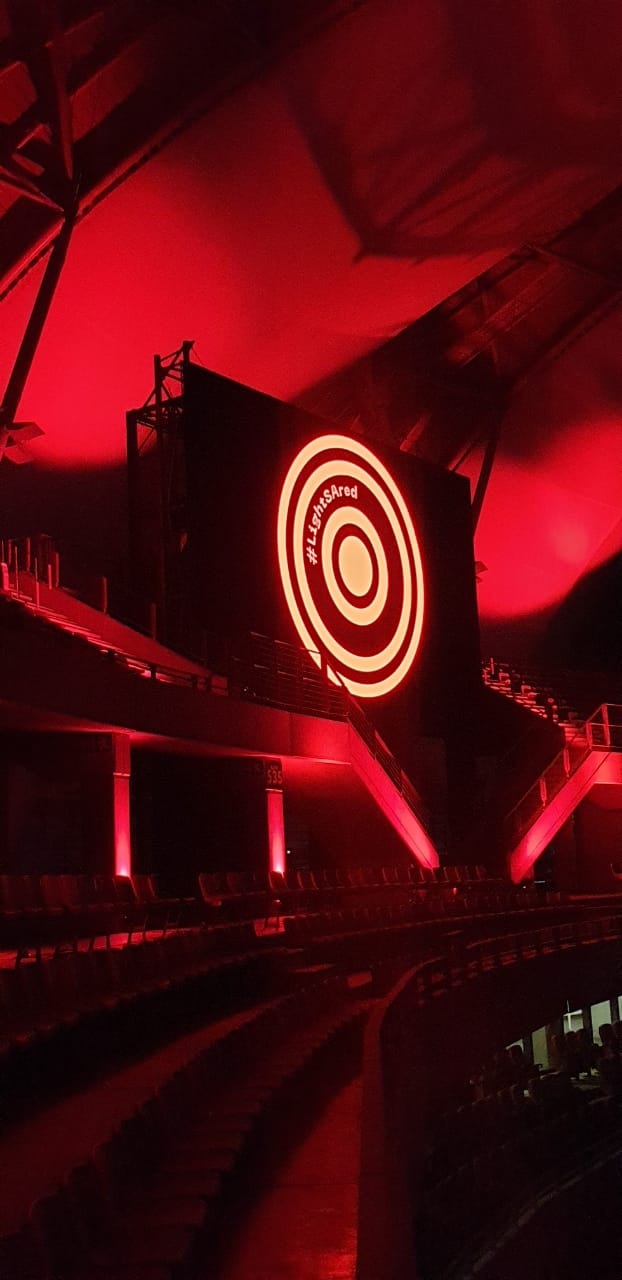 Large red target logo illuminated on stage backdrop.