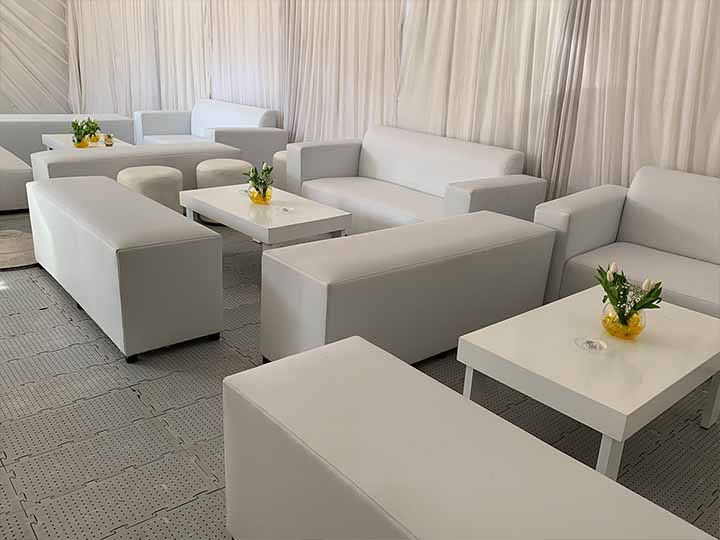 White couches and tables arranged in a lounge area