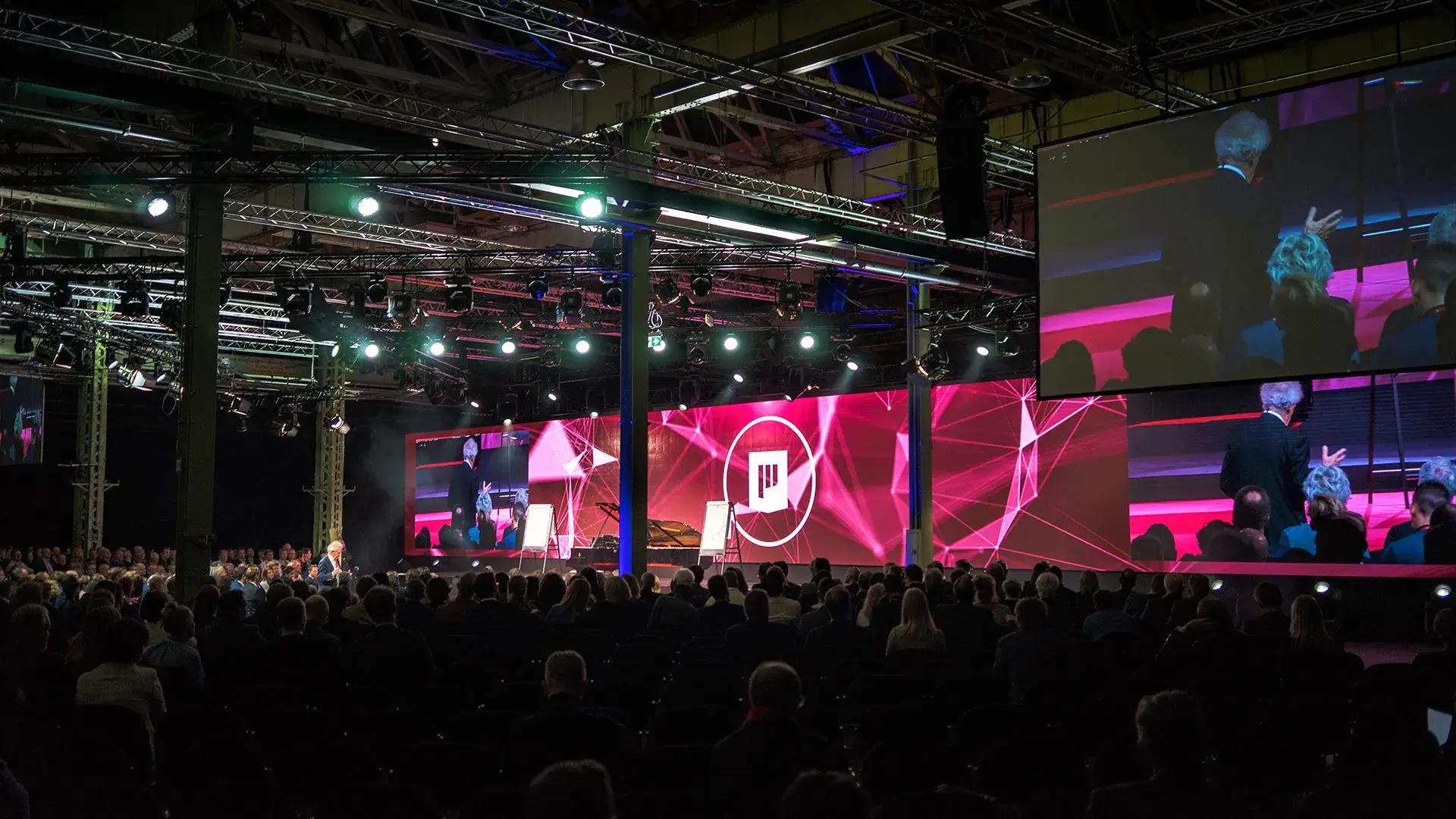 Large LED display setup at an event with colorful graphics