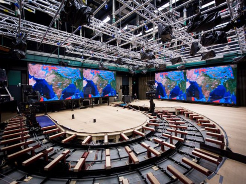 Three large LED screens set up in a circular arrangement