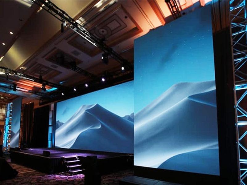 LED screen setup with mountain backdrop and stage lighting.