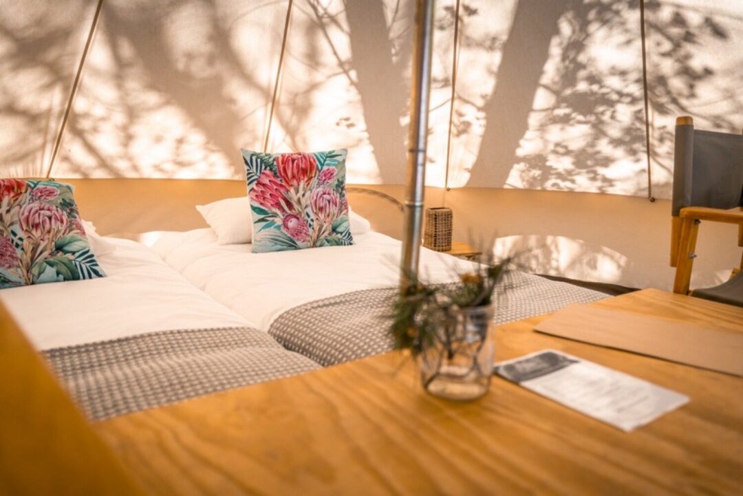Interior of a glamping tent with beds and decor