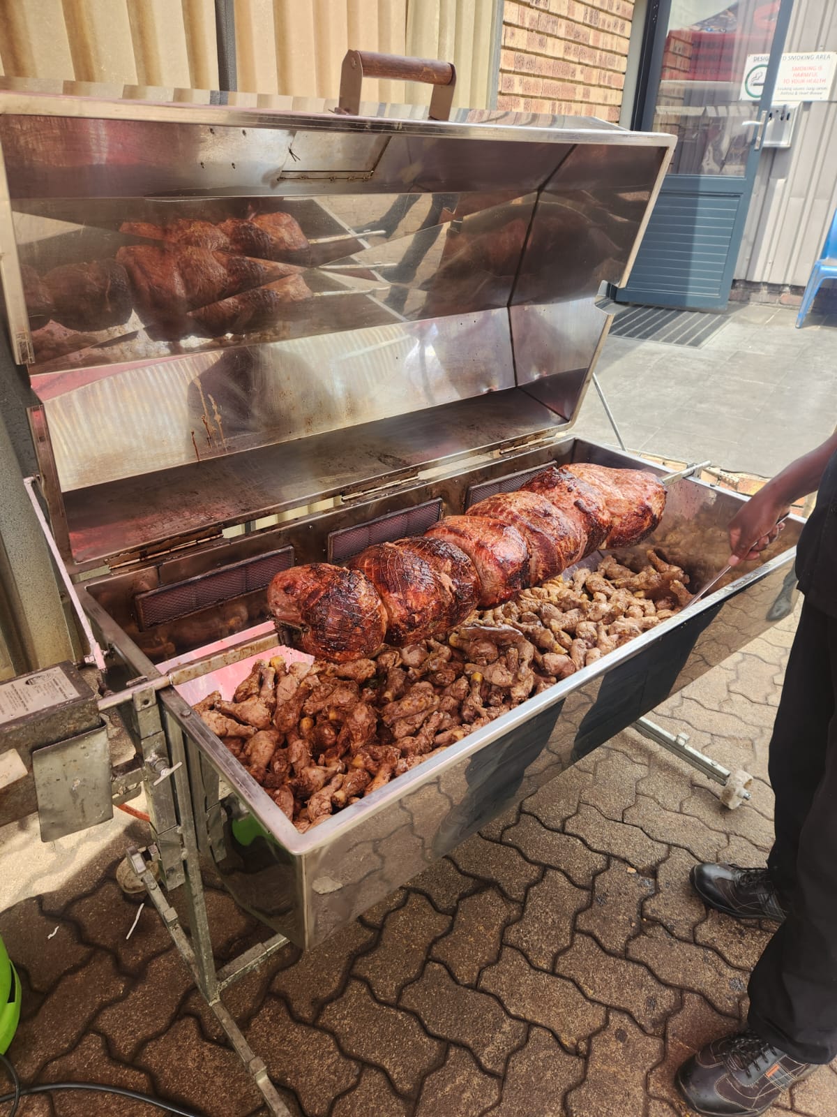 Spit braai grill with roasted meats and chicken