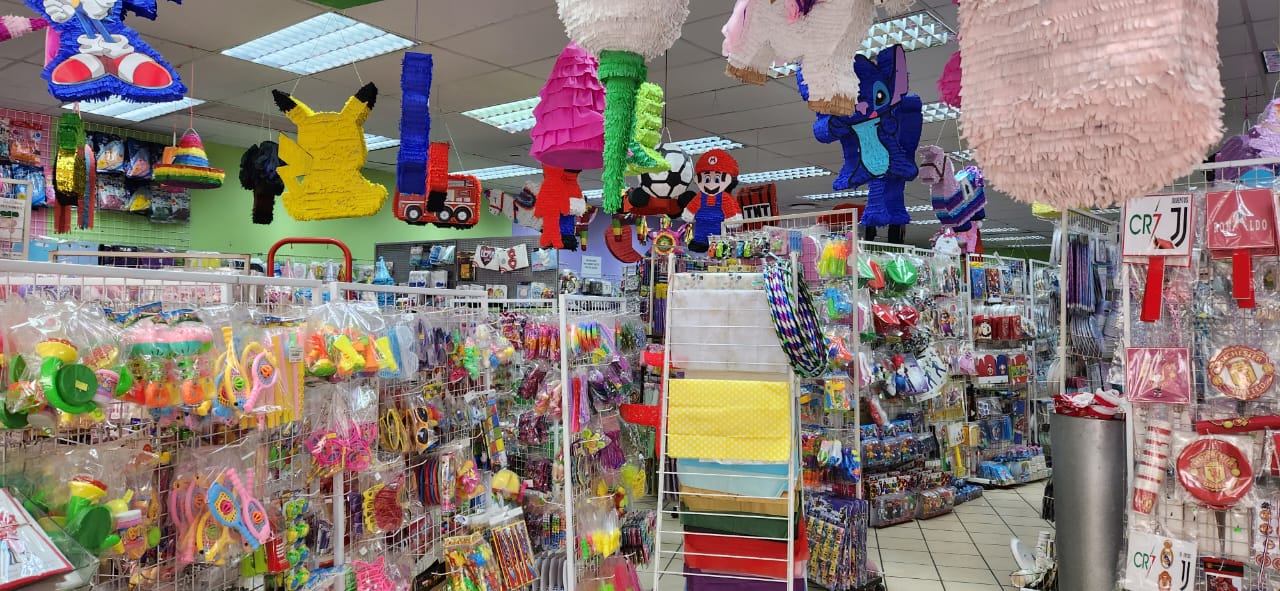 Aisle of party supplies with colorful piñatas and items