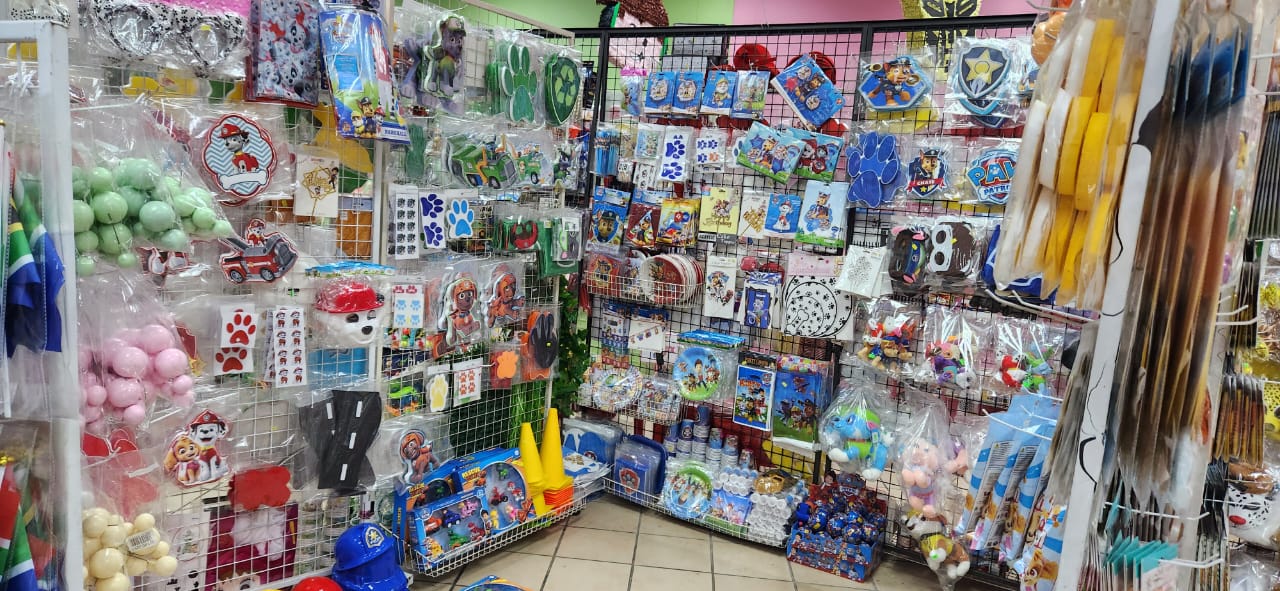 Colorful party supplies arranged on display racks