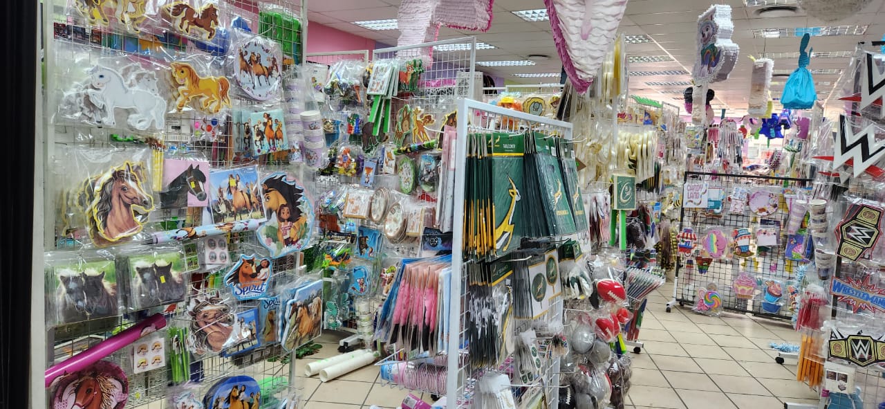Aisle filled with colorful themed party supplies and decorations
