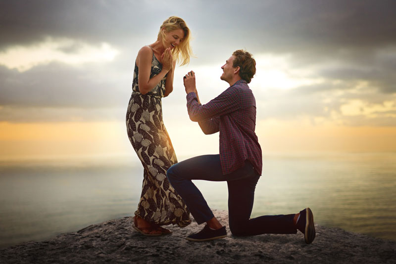 A couple during a beach proposal at sunset in Cape Town