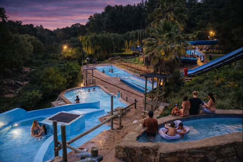 Guests enjoying the pools at The Forest Walk Venue during sunset.