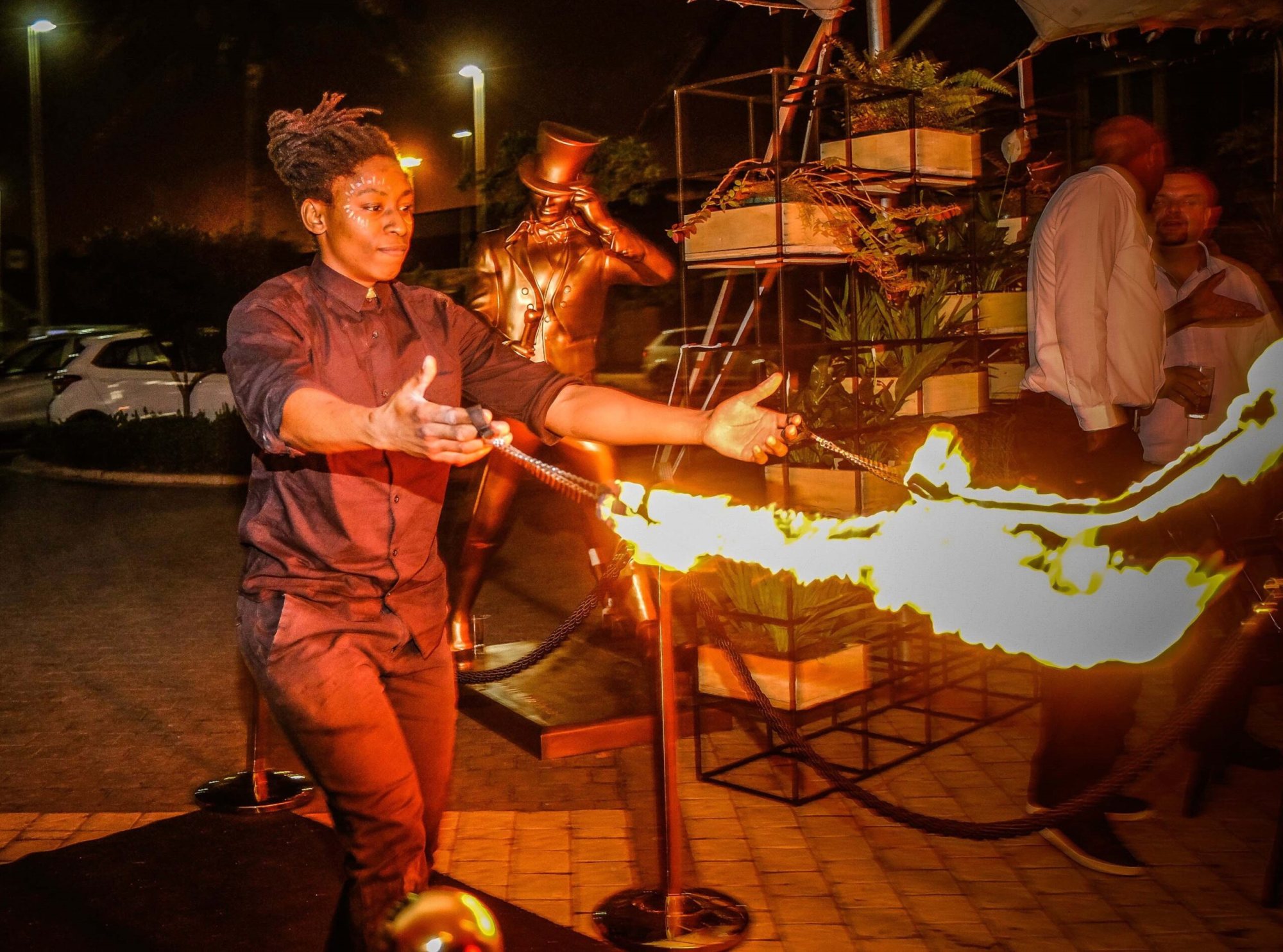 Fire performer in action, swirling flames during a performance.