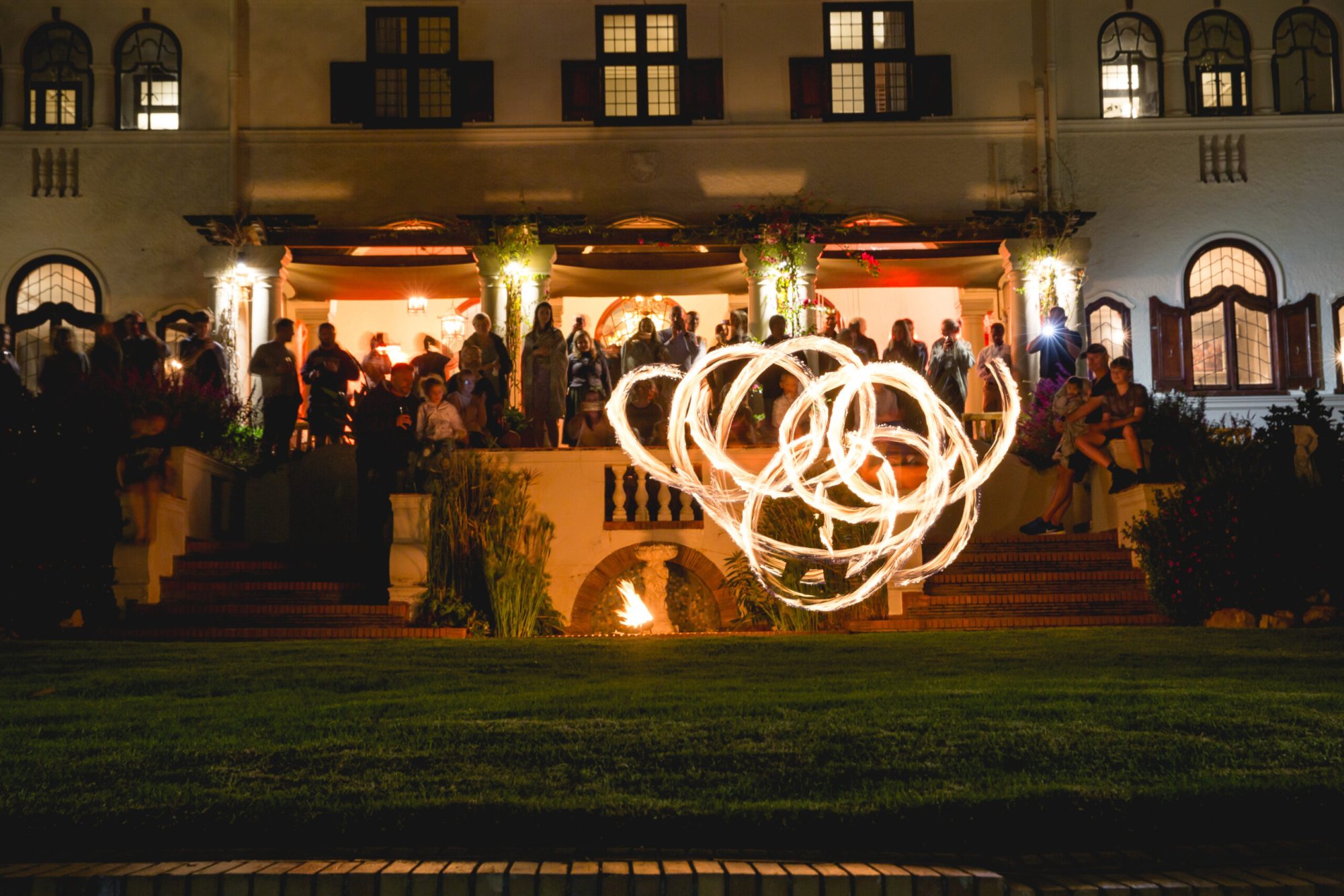 Fire dancers performing in front of an audience at a venue