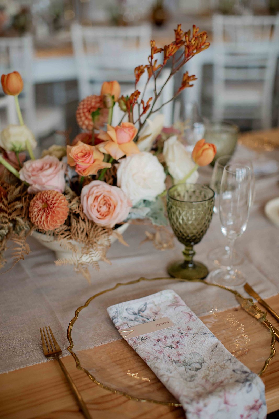 Table setting with floral arrangement, glassware, and linen napkin