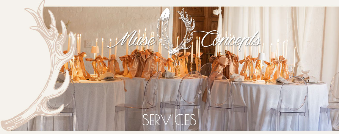 Elegant table setup with white linens and clear chairs