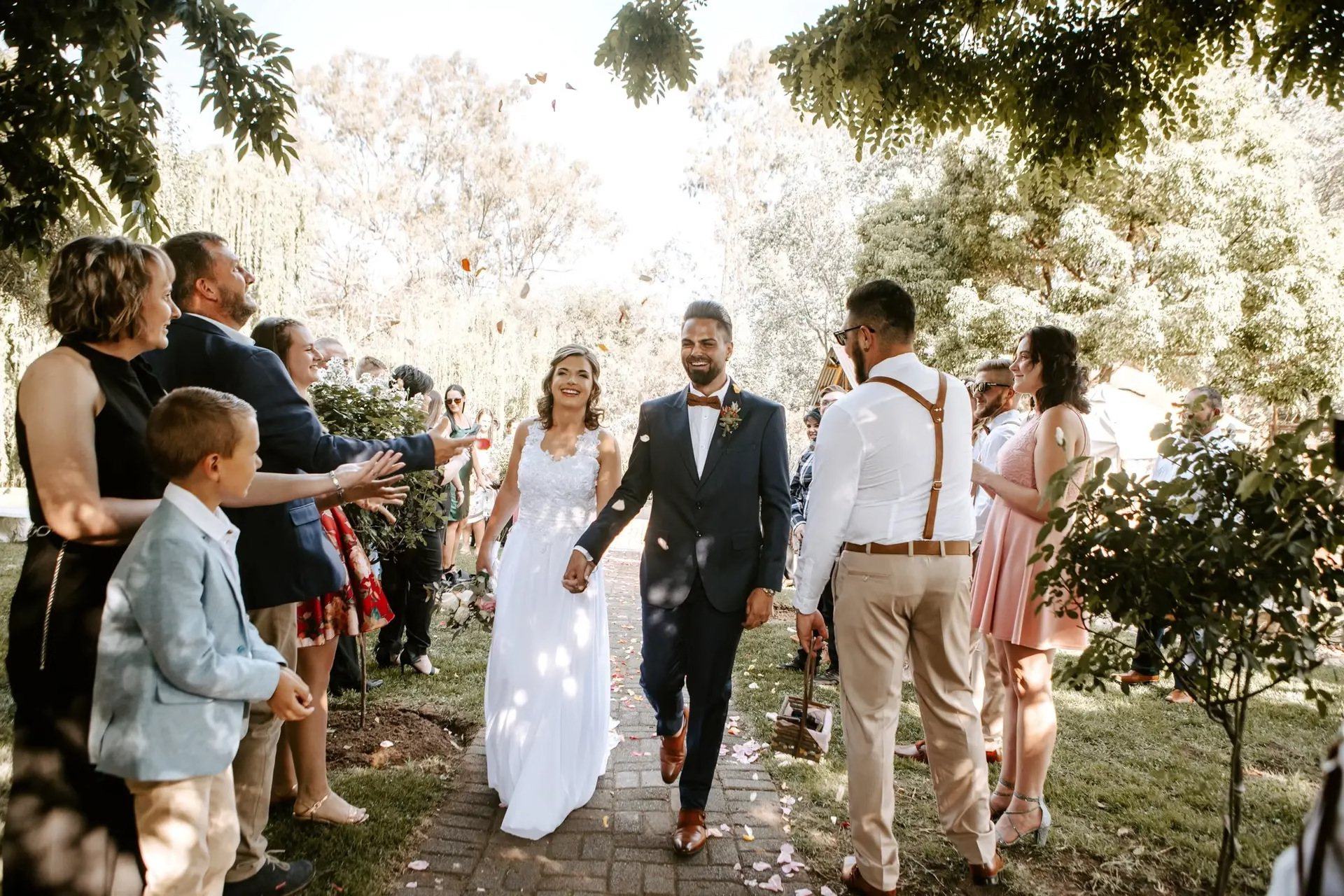 Couple walking down the aisle at an outdoor wedding ceremony