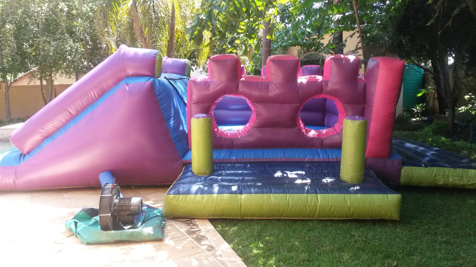 Brightly colored inflatable water castle setup outdoors