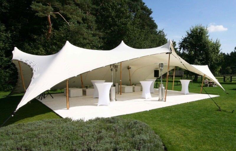 White stretch tent in a grassy outdoor area