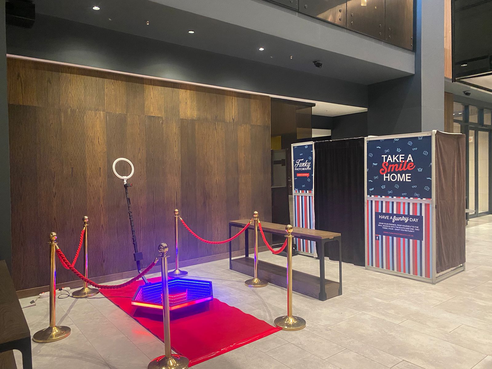Photo booth area with red carpet and backdrop