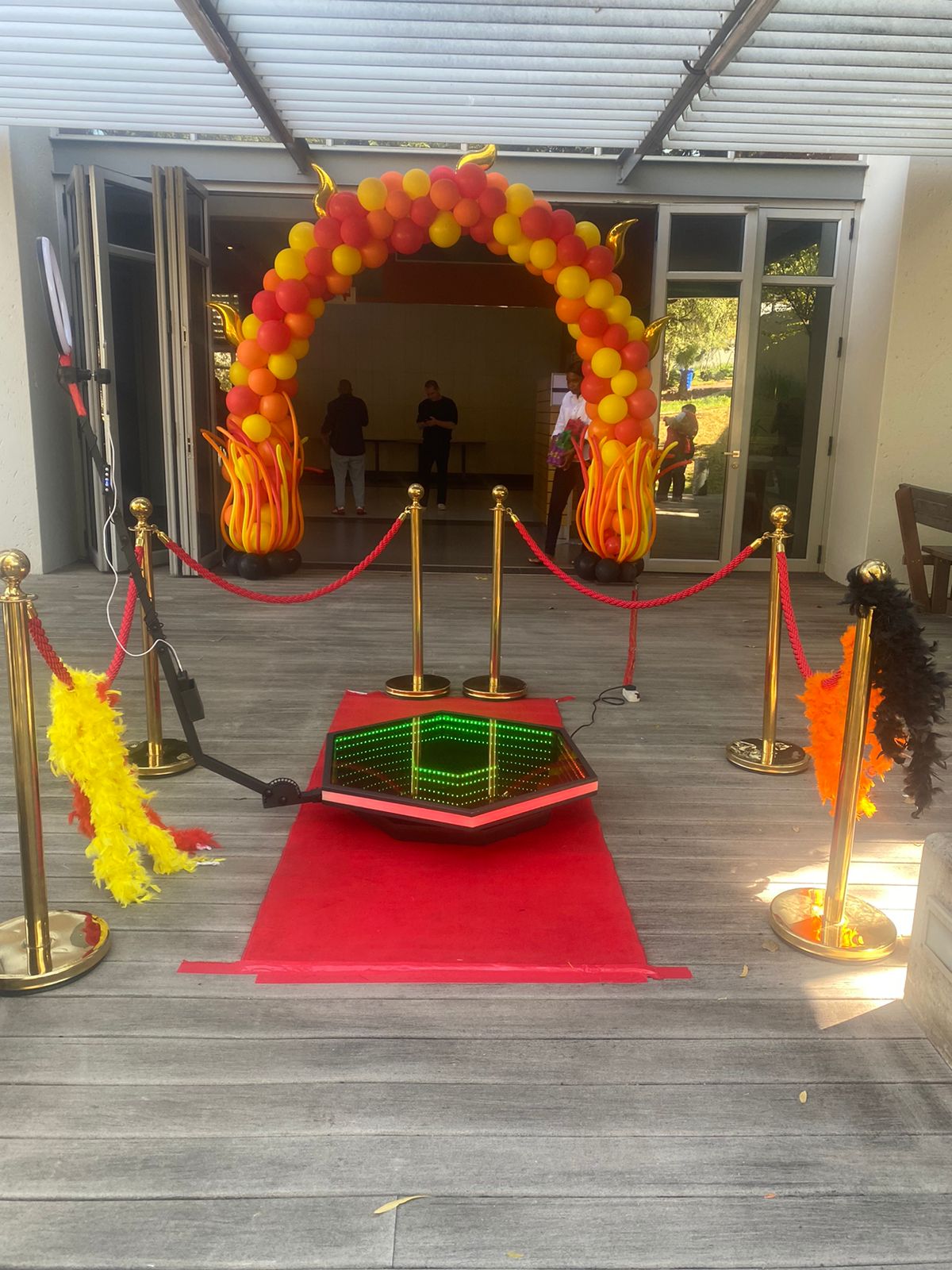 360 video booth with a flame-themed entrance and red carpet