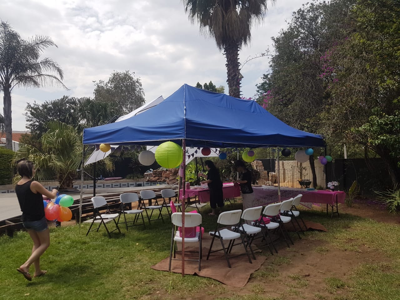 Blue gazebo set up for an outdoor event with decorations