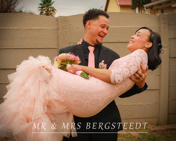 Couple embracing with flowers in a wedding setting