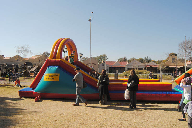 Large inflatable gladiator slide set up in a park