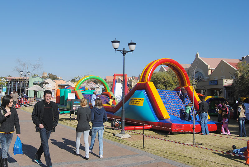 Jumping castle setup with colorful inflatable attractions in a park