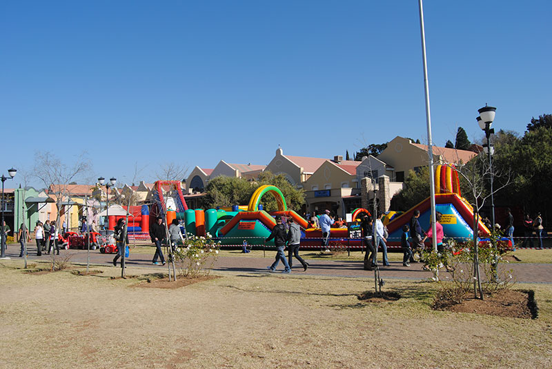 Colorful inflatables with families in a park