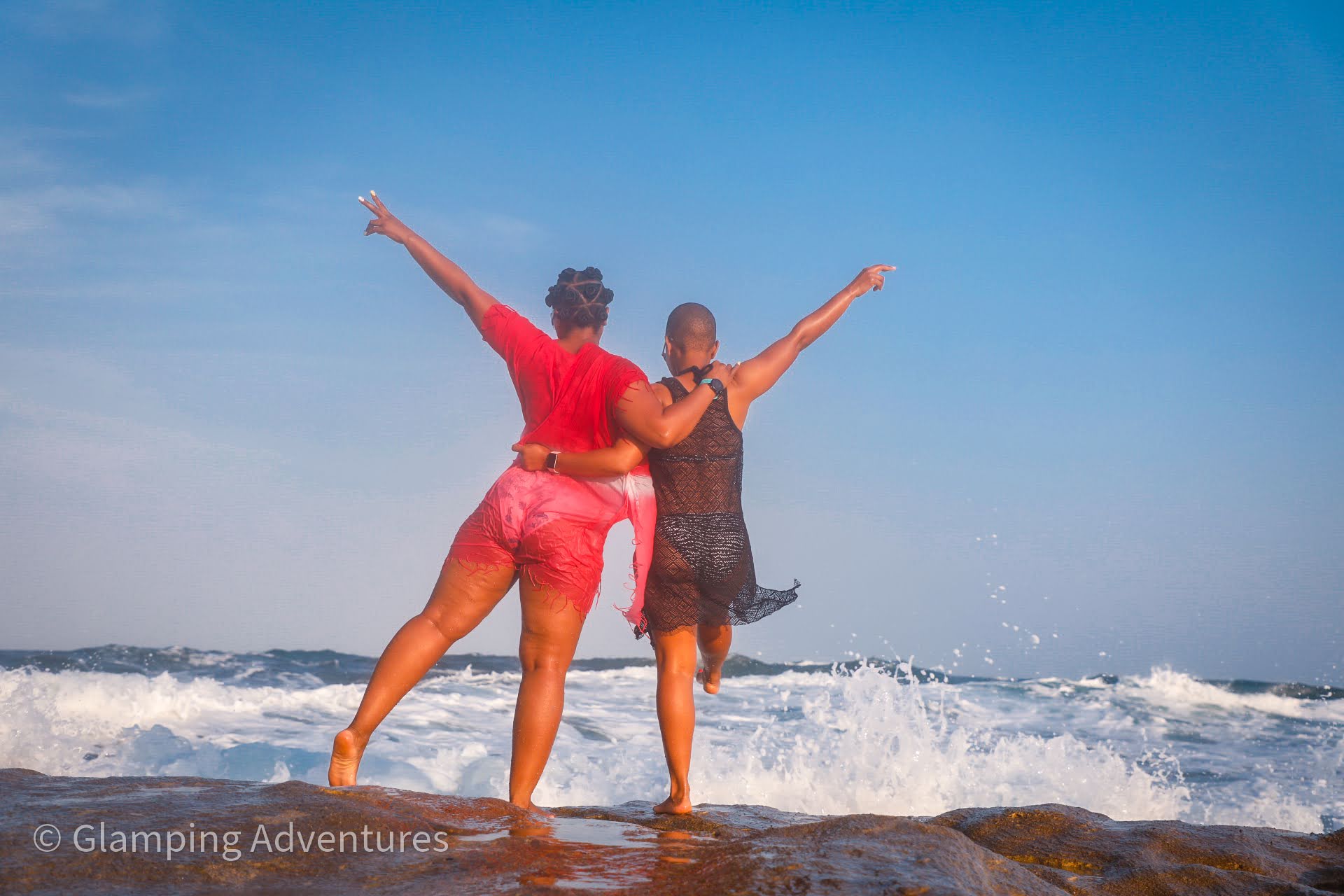 Two women enjoying a beach landscape with waves