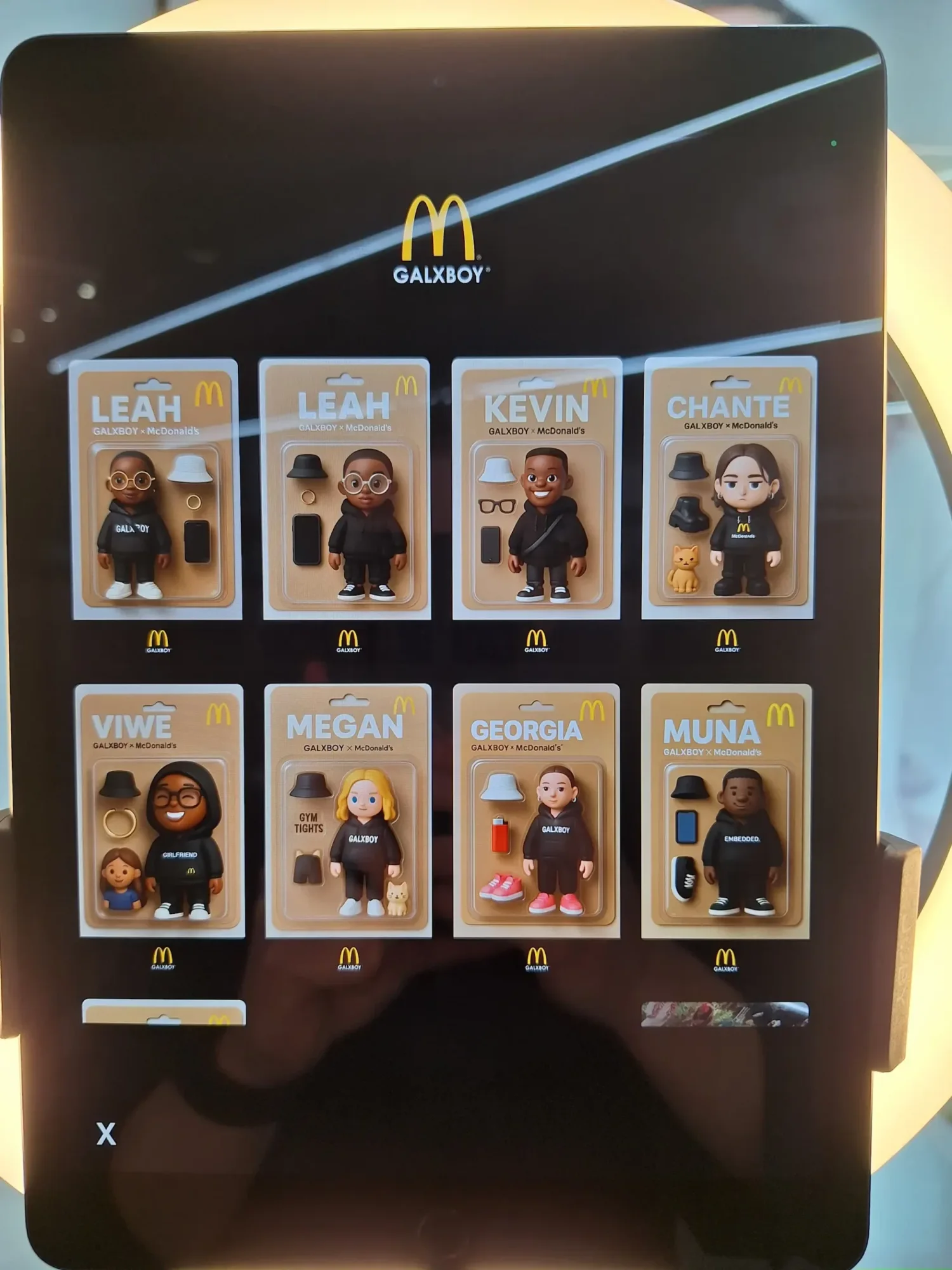 Display of McDonald's collectible figures on a tablet