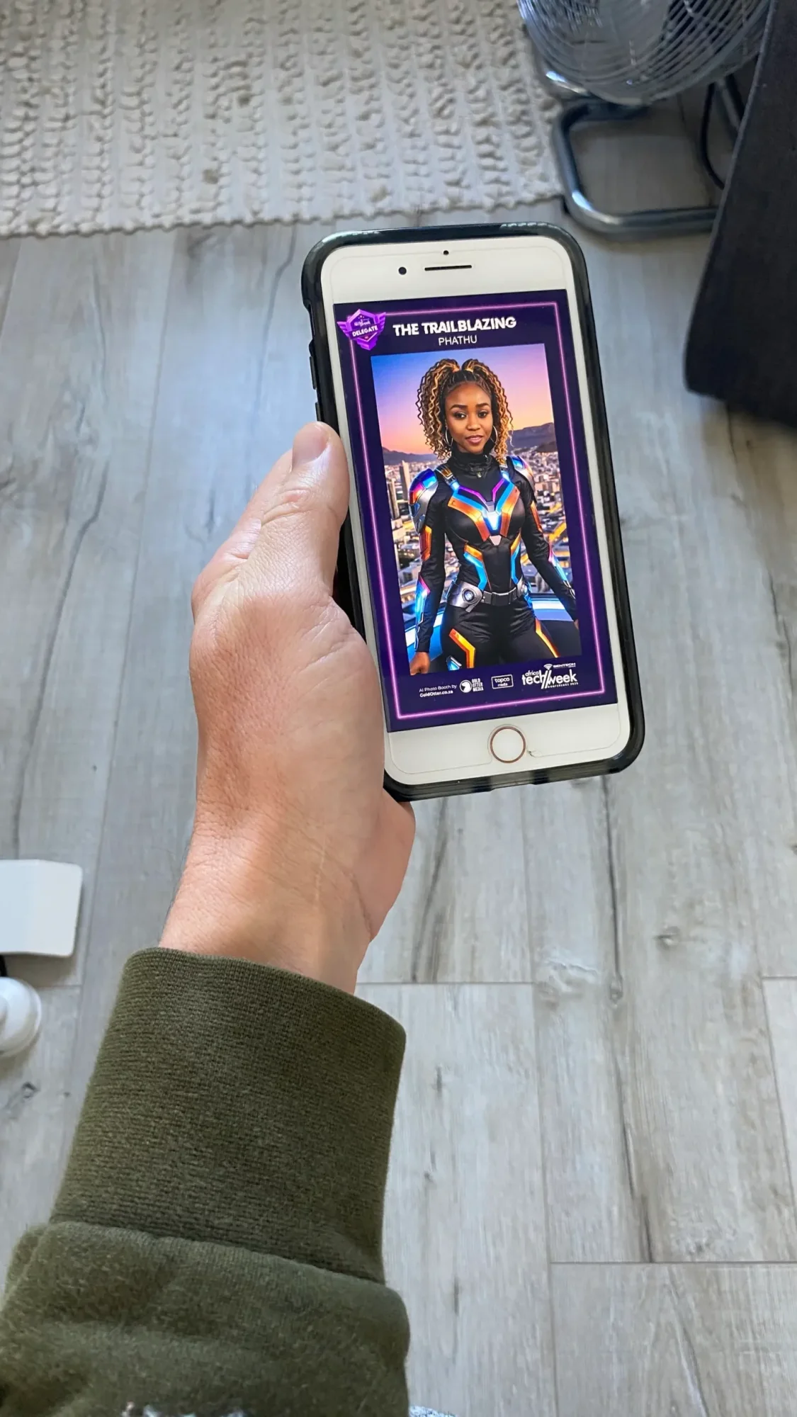Hand holding a phone displaying a digital trading card with a character.