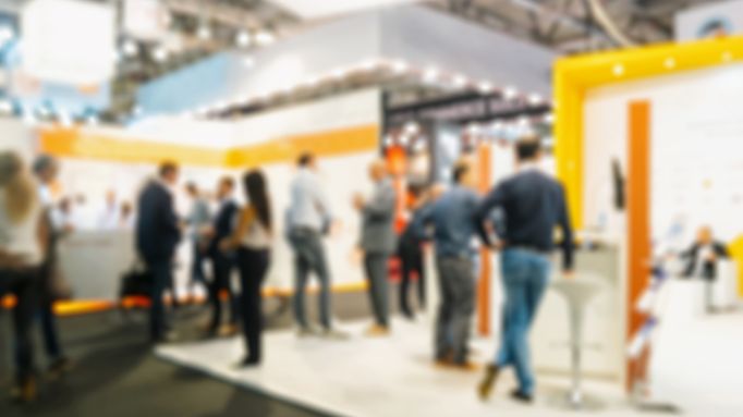 Blurred image of people interacting at an event